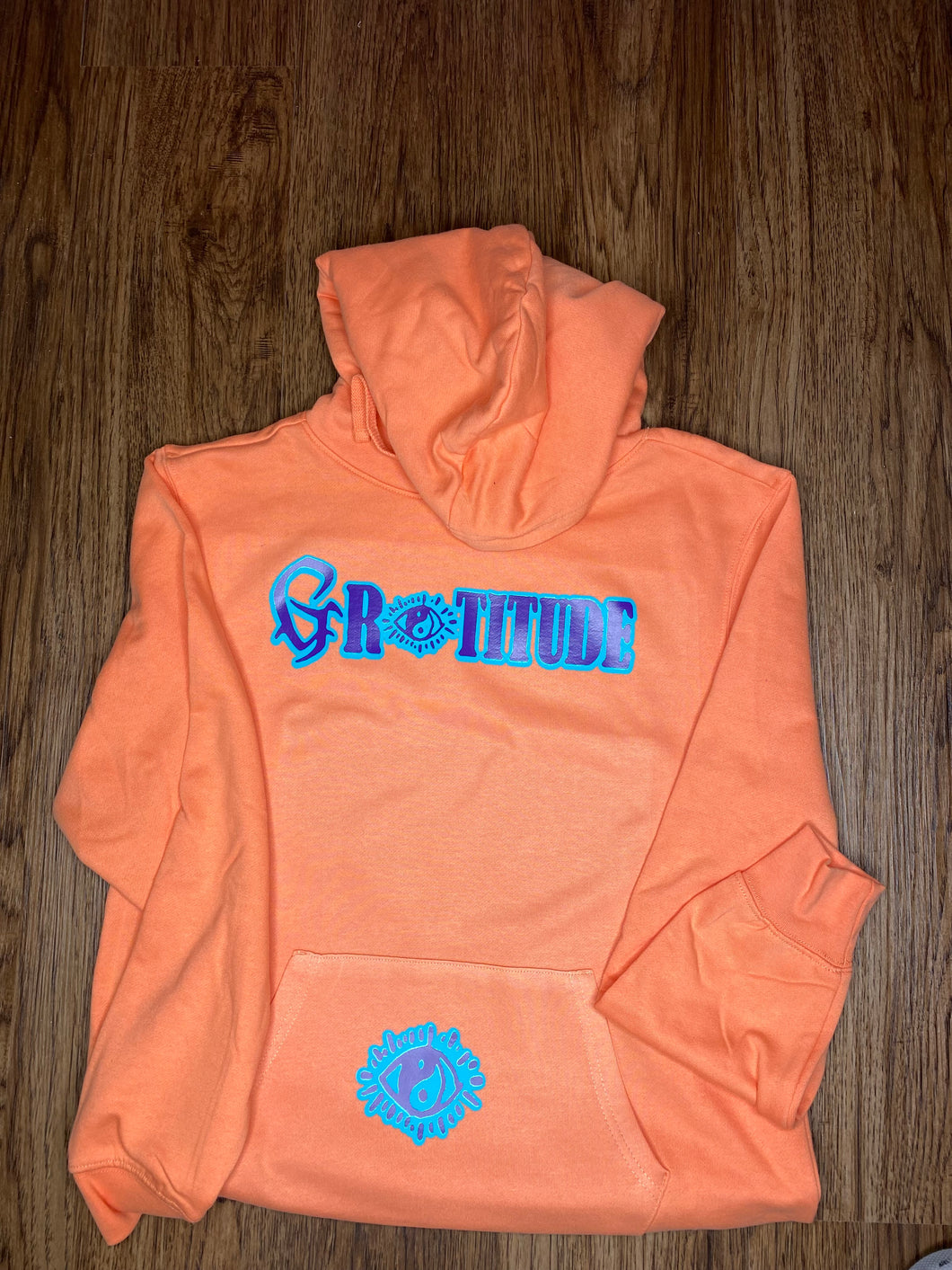 PEACH COLORED HOODIE (PURPLE/AQUA LOGO)